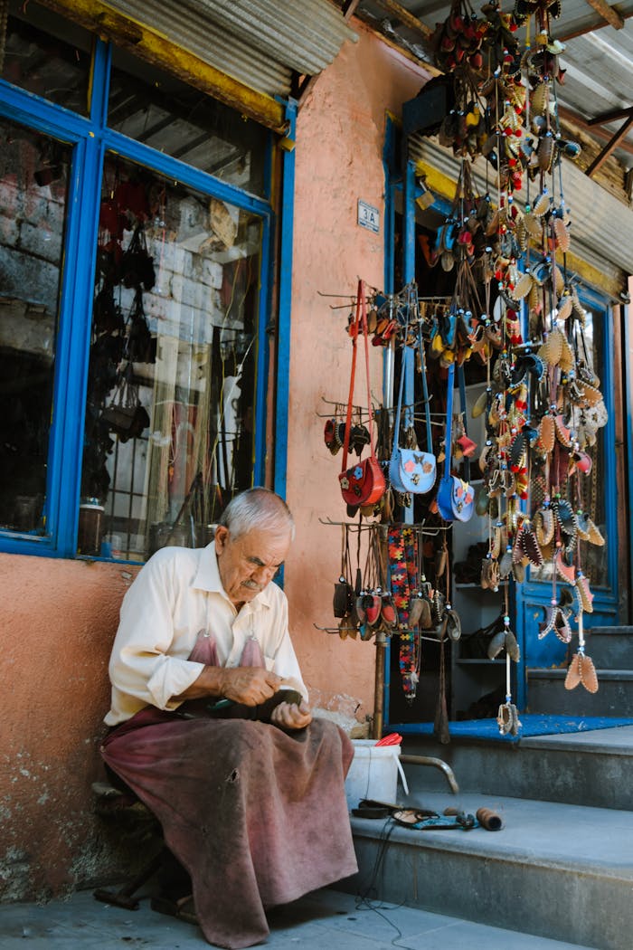 Elderly craftsman making Yemeni shoes outside his workshop in Kahramanmaraş, Türkiye.
